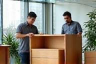 Furniture delivery team setting up in an office